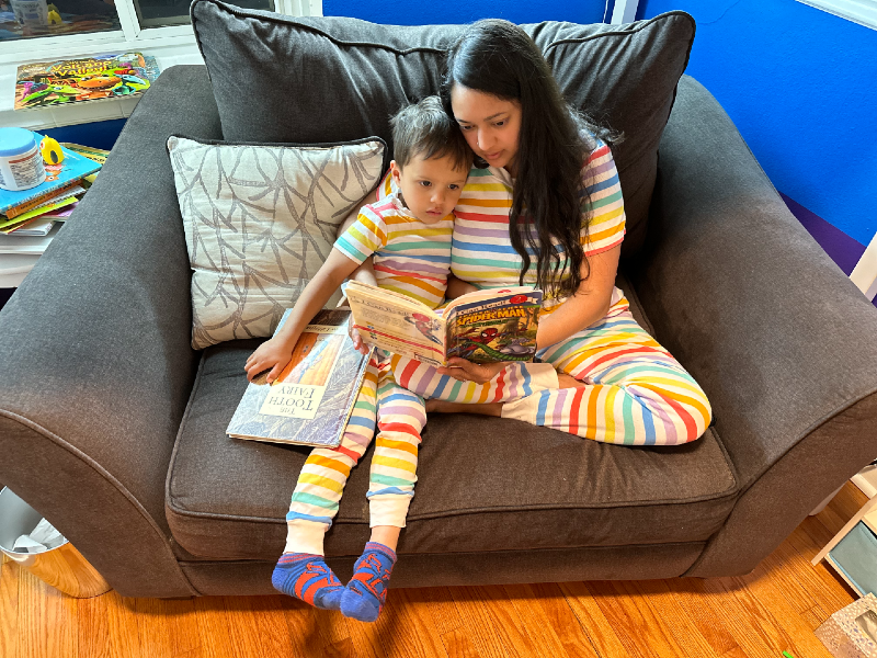 Neem and Logan reading a Spider-Man book in his room