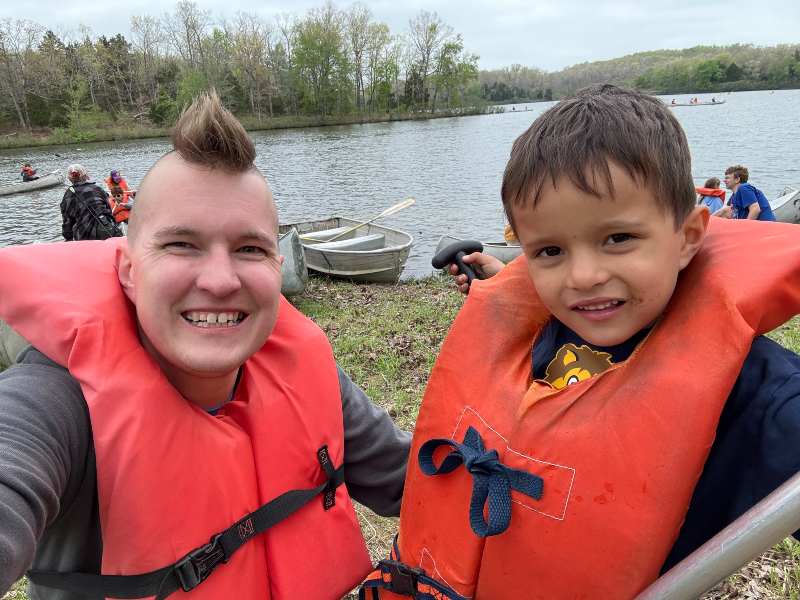 Mark and Logan wearing Cub Scouts life jackets